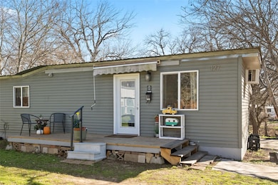 View of front facade featuring a wooden deck