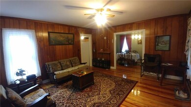 Another view of living room with dining room and k