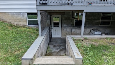 Doorway to property featuring a patio