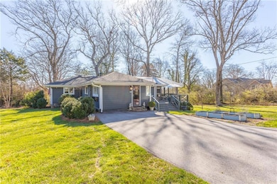 View of front of home with a front lawn and drivew