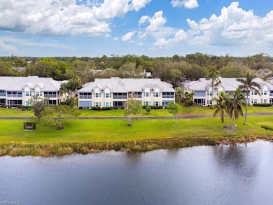 Birds eye view of property with a water view