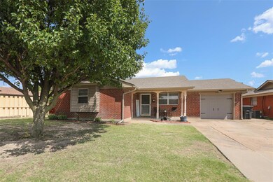 View of front of house with a front yard and a gar