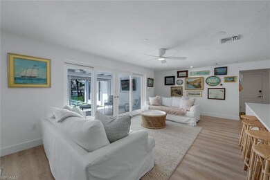 Living room with ceiling fan, french doors, and li