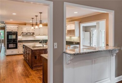View of kitchen from den with bar area showing. 