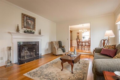 Fireplace with classic mantel, beautiful hardwoods in living room.