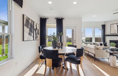 Bright dining area *Photos of furnished model. Not