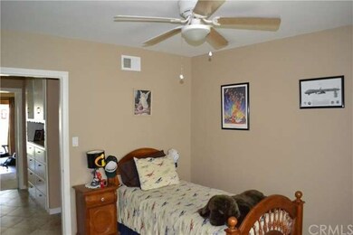1st bedroom with ceiling fan, walk-in closet, and 