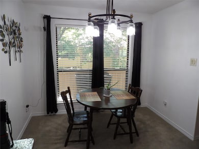 Dining space with a notable chandelier looking ont