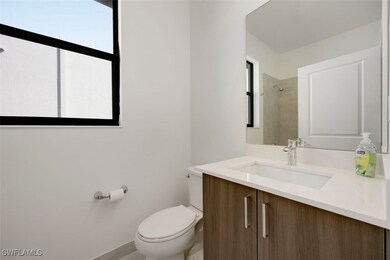 Full bathroom with toilet and vanity
