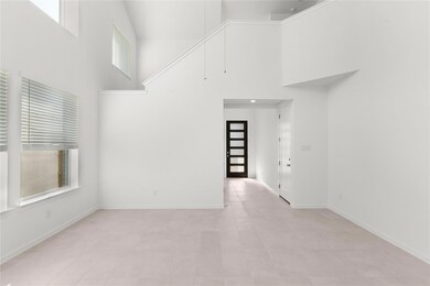 Empty room featuring a high ceiling, plenty of na
