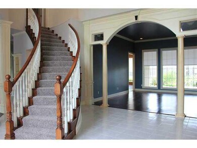 Other. Entry way leads to curved staircase and liv