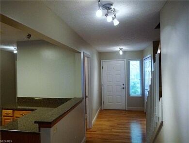 First level entrance, with wood floors, and track 