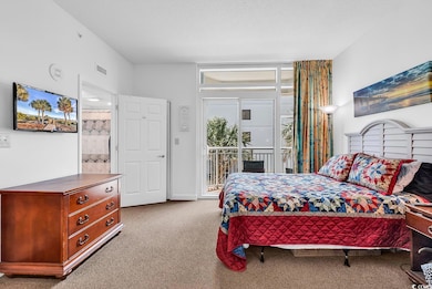Carpeted bedroom featuring access to outside