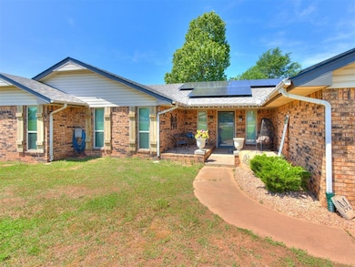 Ranch-style house with a front lawn, brick siding,