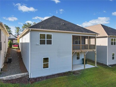 Back of property featuring a patio area and a lawn