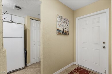 Entryway.  Pantry next to refrigerator.  Laundry r
