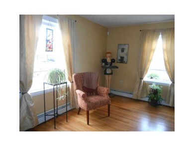 Living Room. Nice big windows and hardwood floorin