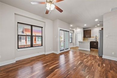 Unfurnished living room with dark wood-style floo