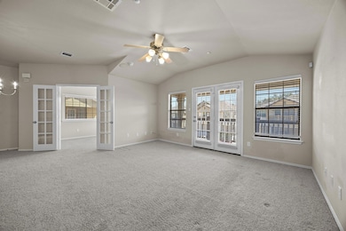 Carpeted spare room featuring lofted ceiling, ple