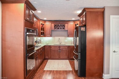 Stunning kitchen with cherry cabinets and a double