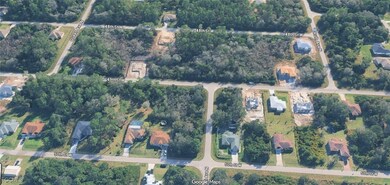 Aerial view of property and surrounding area with a tree filled landscape