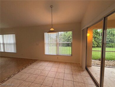 Empty room with light tile patterned floors and ba