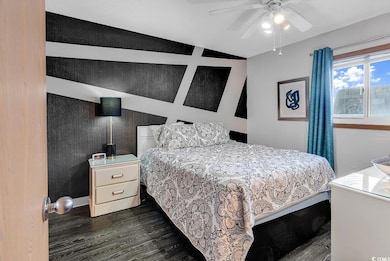 Bedroom featuring dark wood-type flooring and a ce