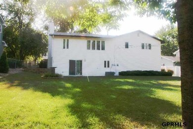 Large fenced back yard with mature landscaping and mature trees