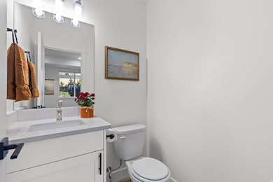Half bathroom with vanity and toilet