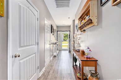Entryway with wood finished floors and baseboards