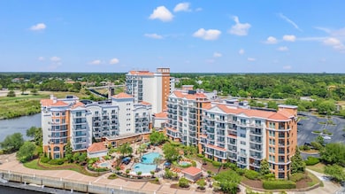Aerial view of apartment complex / building and a pool