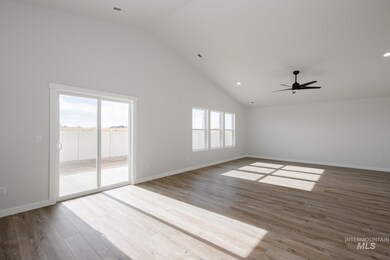 Spare room featuring high vaulted ceiling, light wood-style flooring, recessed lighting, and a ceiling fan