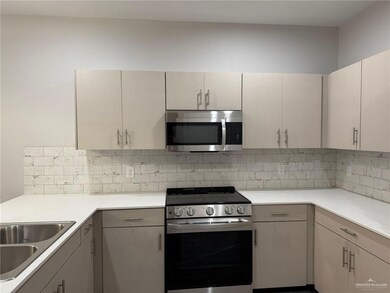 Kitchen featuring backsplash, sink, and stainless steel appliances