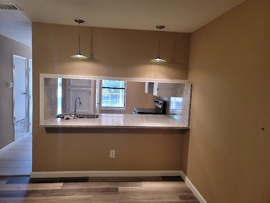Kitchen with wood finished floors, electric stove,