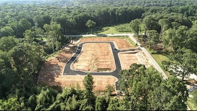 View of property location featuring a heavily wooded area