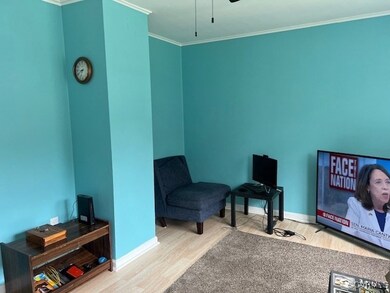 Sitting room featuring crown molding, wood finishe