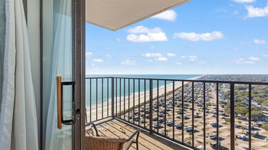Balcony with view of water and beach