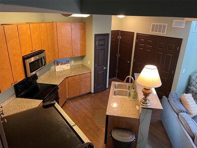 Kitchen featuring stainless steel microwave, blac