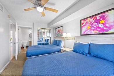 Bedroom with carpet, ceiling fan, and a closet