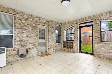 Bright and inviting solarium with elegant brick wa
