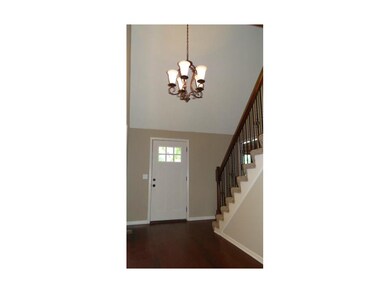 Stunning entry with iron balusters and maple floor