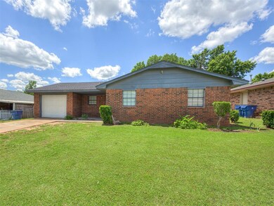 Ranch-style house featuring concrete driveway, an attached garage, and brick siding
