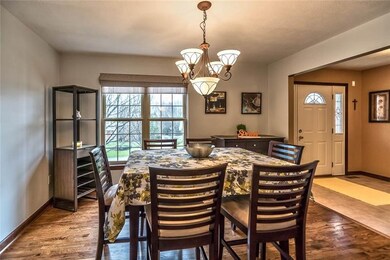 Front dining room features wood flooring, broad wi