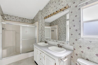 This bathroom features dual sinks with a large mir