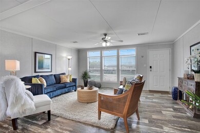 Living room featuring wood finished floors, crown