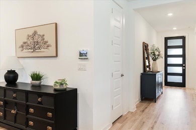 Foyer entrance with light wood-type flooring and 