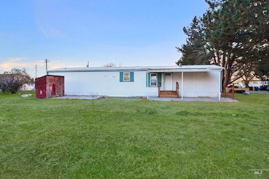 View of front of house with a front lawn, a metal roof, a porch, and an outbuilding