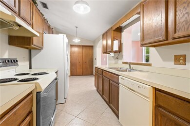 Kitchen with view of pass thru, eat in space and p
