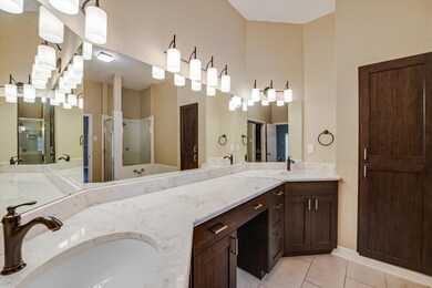 Full bath featuring tile patterned floors, double