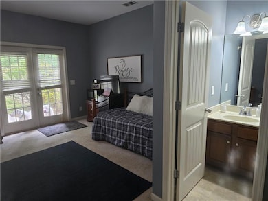 Bedroom with french doors, baseboards, a sink, lig